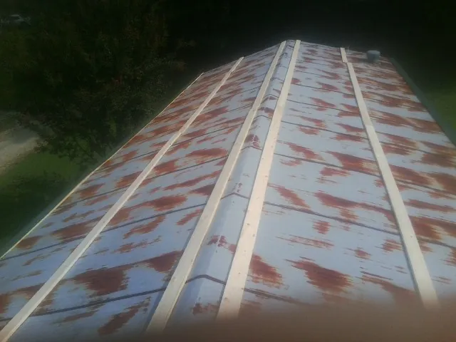 Rusted metal roof panels with new wood purlins before replacement — Storm Damage Roof Repair in Lathrop by Roofing Brothers